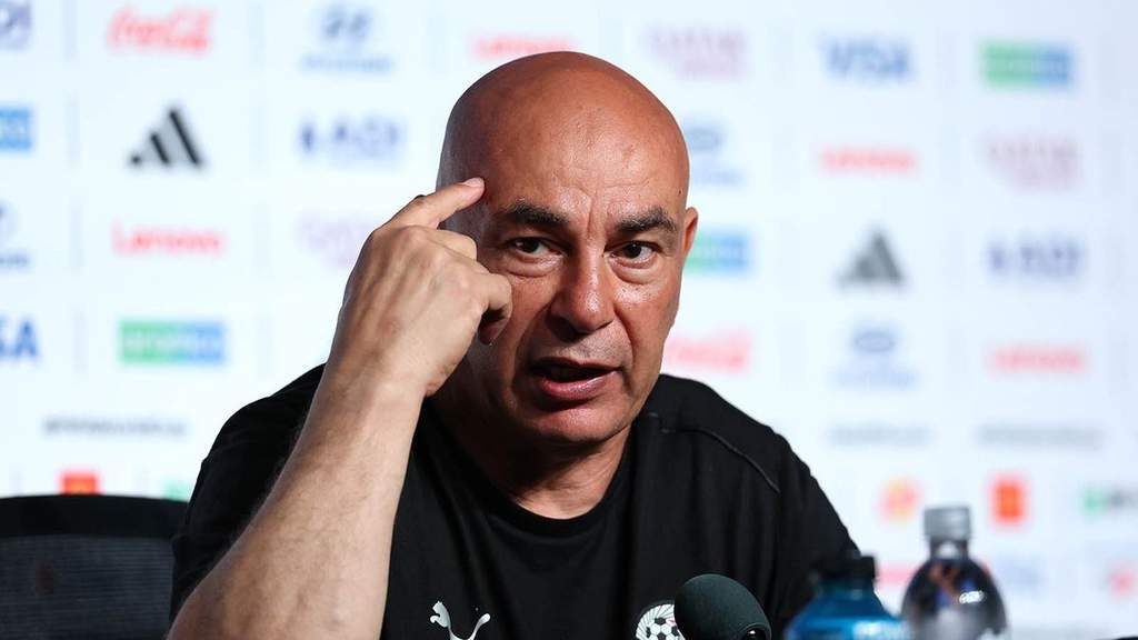 Manajer Mesir Hossam Hassan membuat isyarat X di depan wasit Francois Letexier