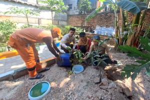 Petugas dan warga membuat lubang biopori dari ember bekas di pemukiman Kelurahan Paseban